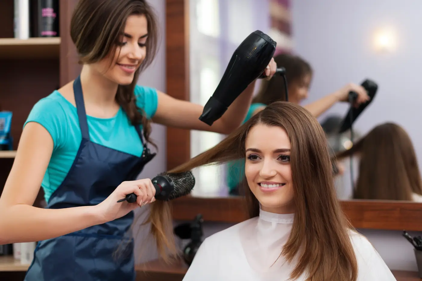 female-hairdresser-using-hairbrush-hair-dryer